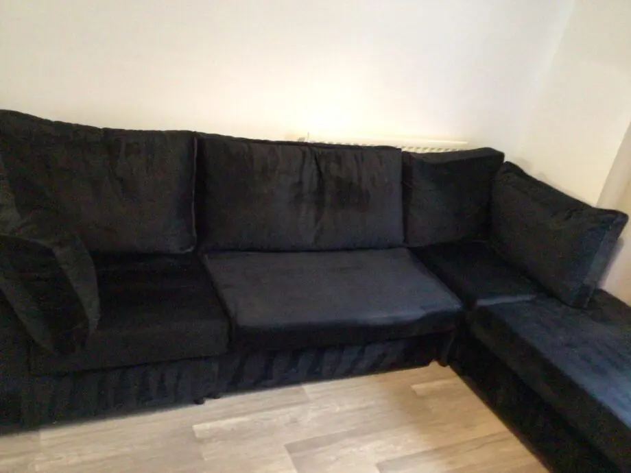 Black plush corner sofa