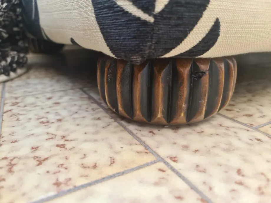 DFS Black and neutral palm leaf pattern fabric armchair and matching footstool