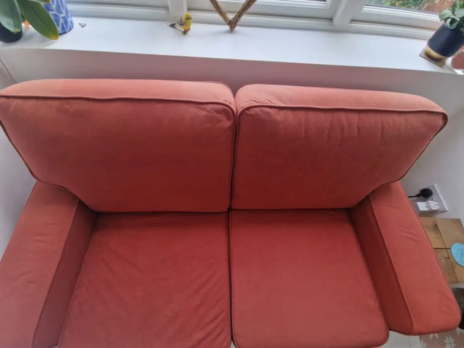 Two lovely matching comfy rust/orange sofas