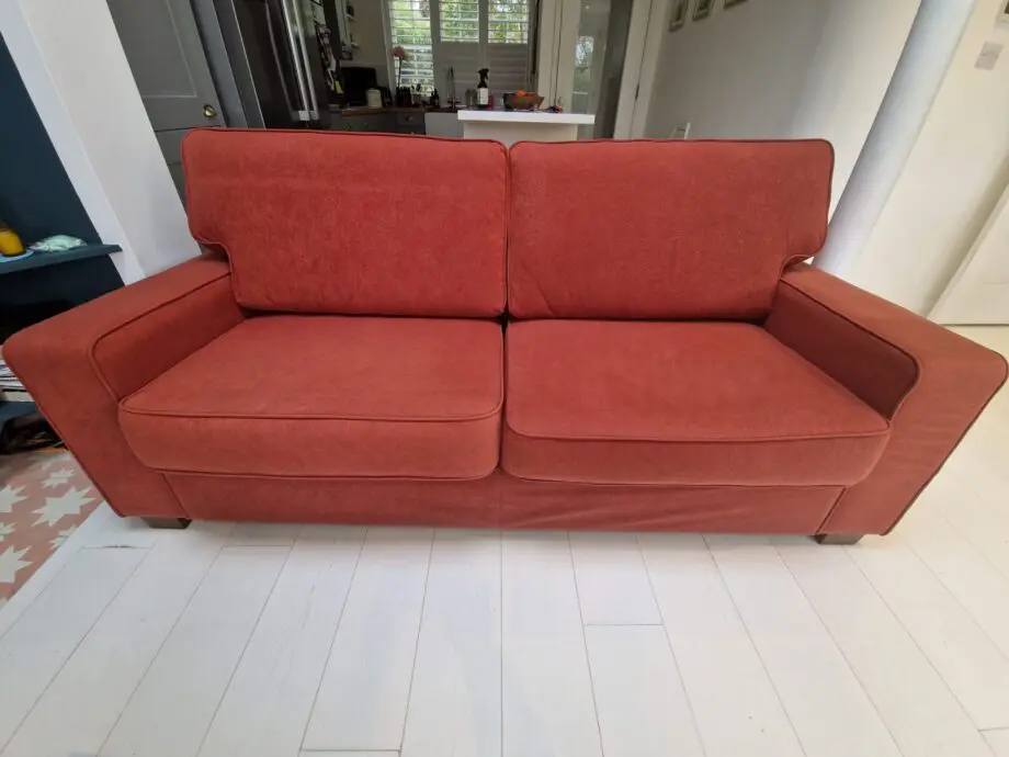 Two lovely matching comfy rust/orange sofas
