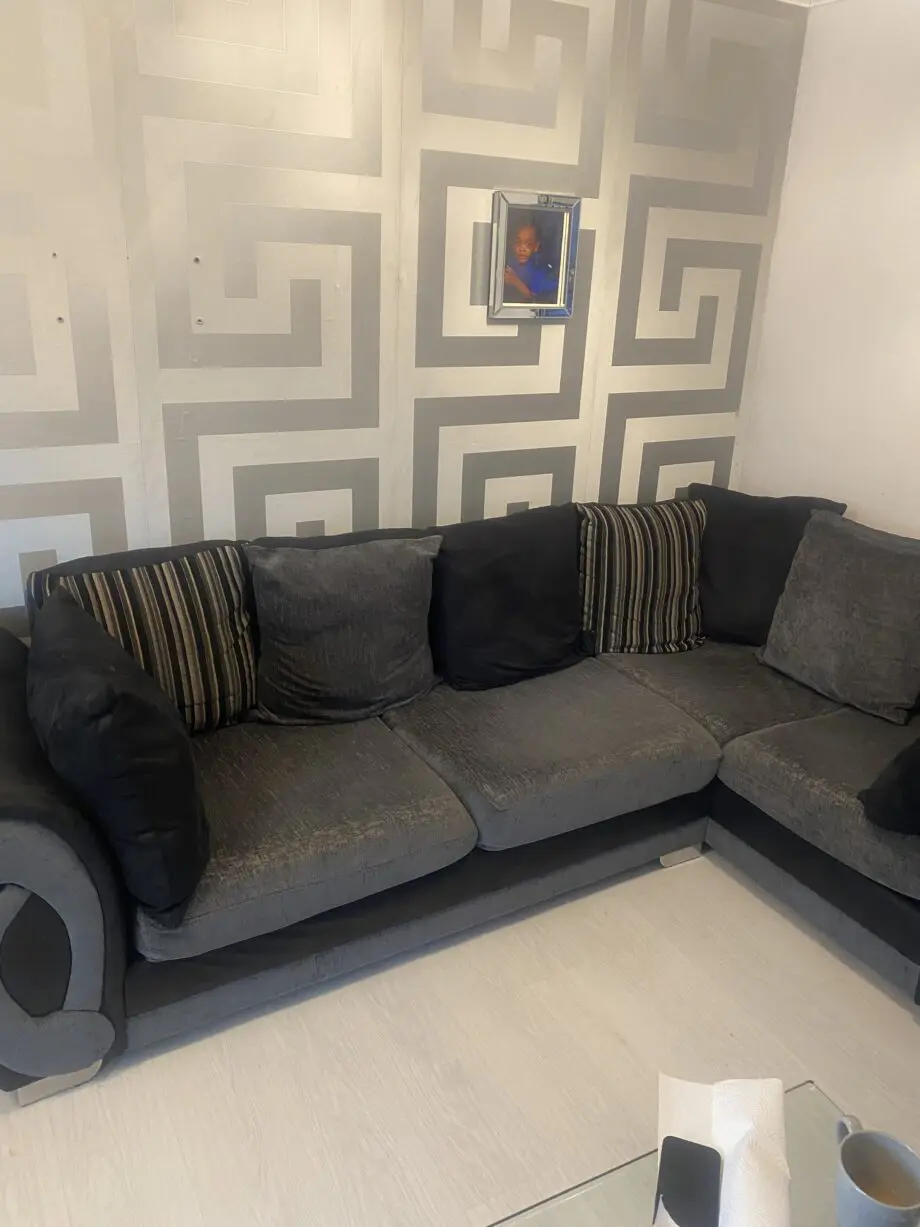 Grey and black corner sofa and round swivel chair