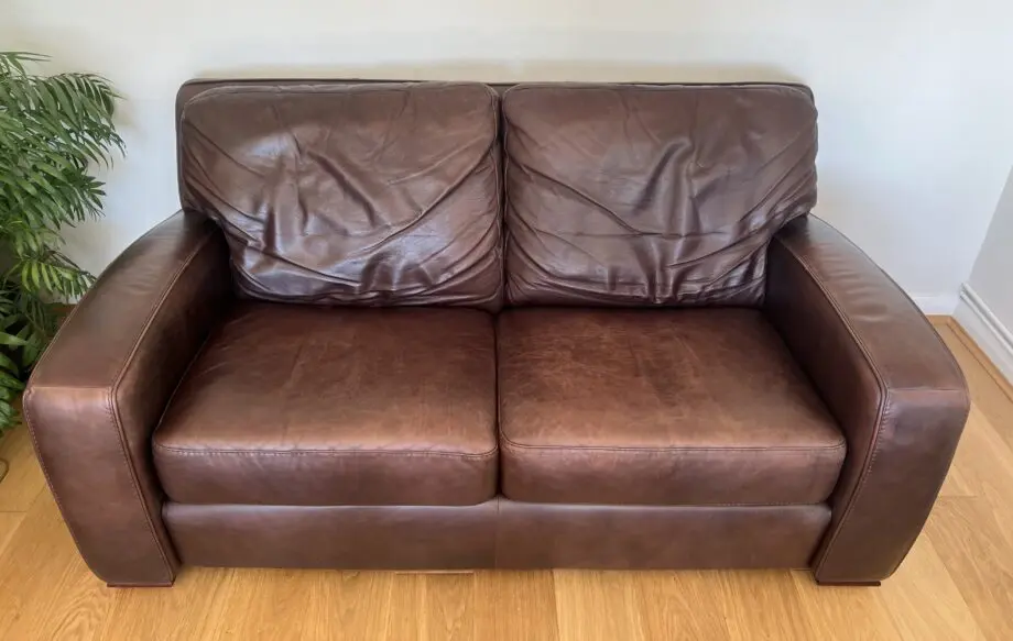 2 leather sofas and footstool made by David Paine Associates for John Lewis. Style is Baltimore a modern interpretation of a retro classic